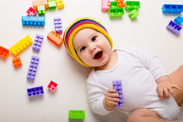 baby-boy-playing-with-multi-colored-constructor-white-wall_98296-1967.jpg